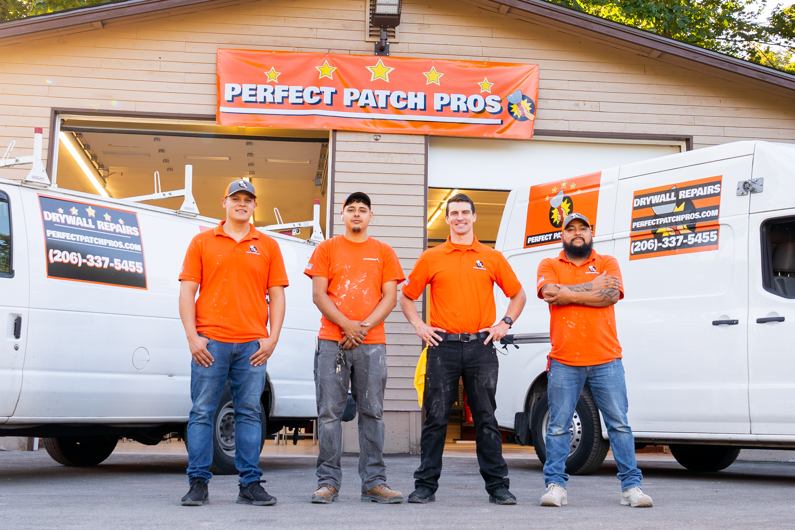 The Perfect Patch Pros crew in front of their branded drywall repair vans in Kent, WA