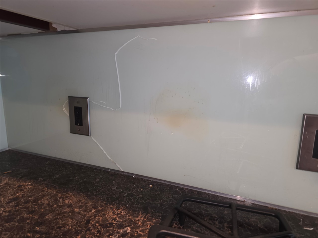 Wall cracks and water stains before drywall repair