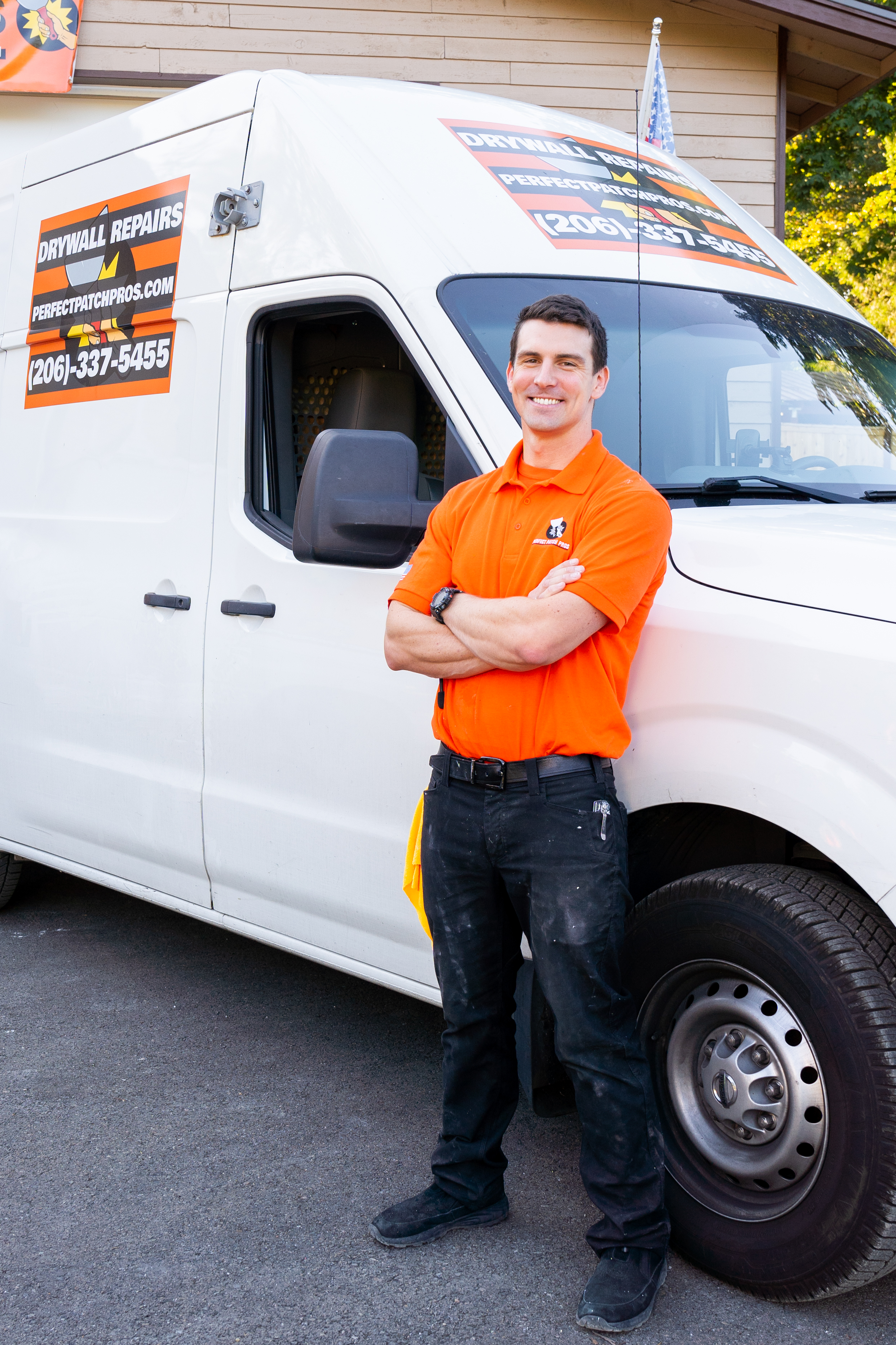 Indigo Keeslar, owner of Perfect Patch Pros, beside a branded drywall repair van in Kent, WA